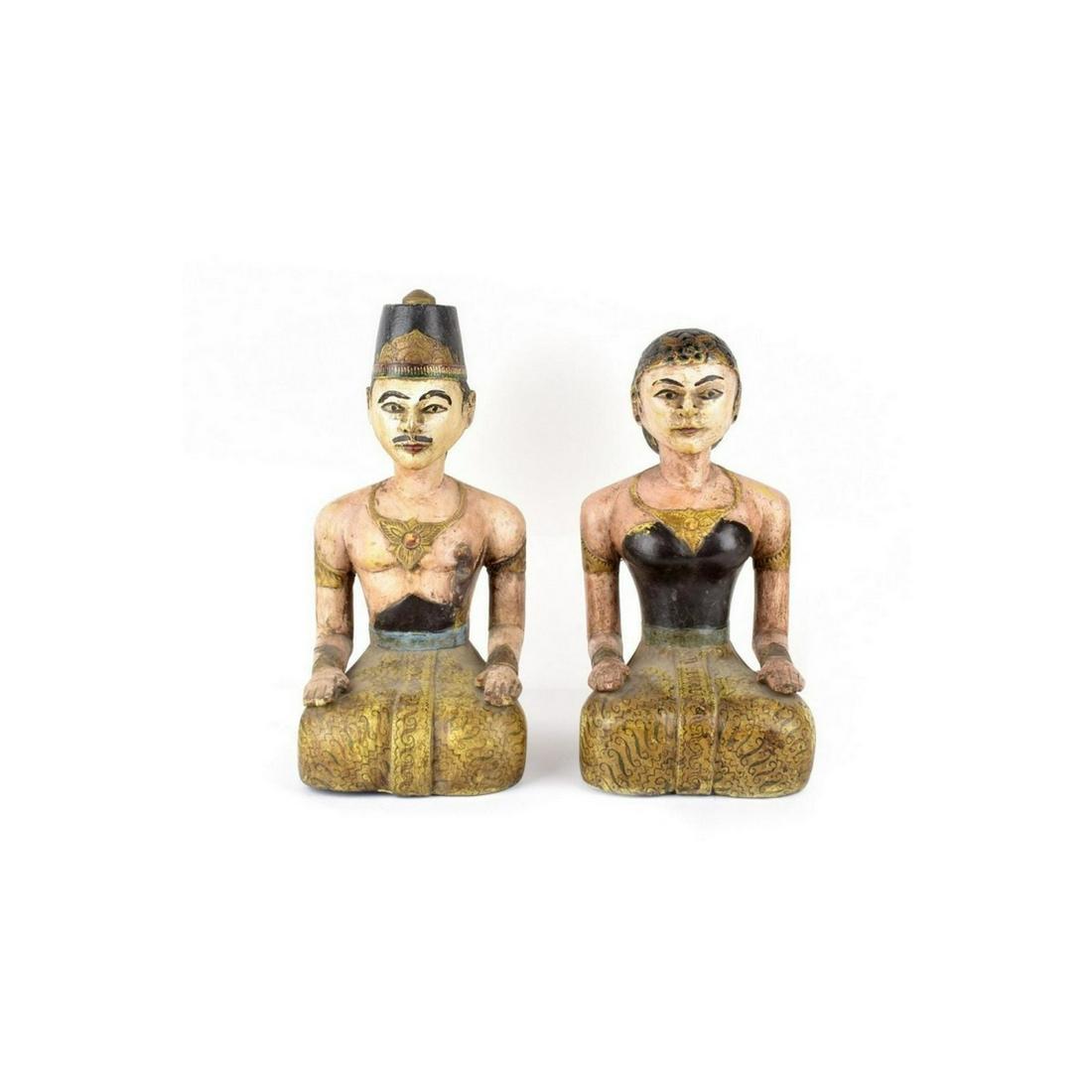 Pair of Javanese Wedding Couple: Pair of Javanese Loro Blonyo Polychromed Carved Wood Wedding Couple. Dressed in traditional garment. Female measures 12-3/4" x 6-1/2" x 8-1/2". Male measures 14-1/4" x 7" x 8-1/2". Condition: Good con