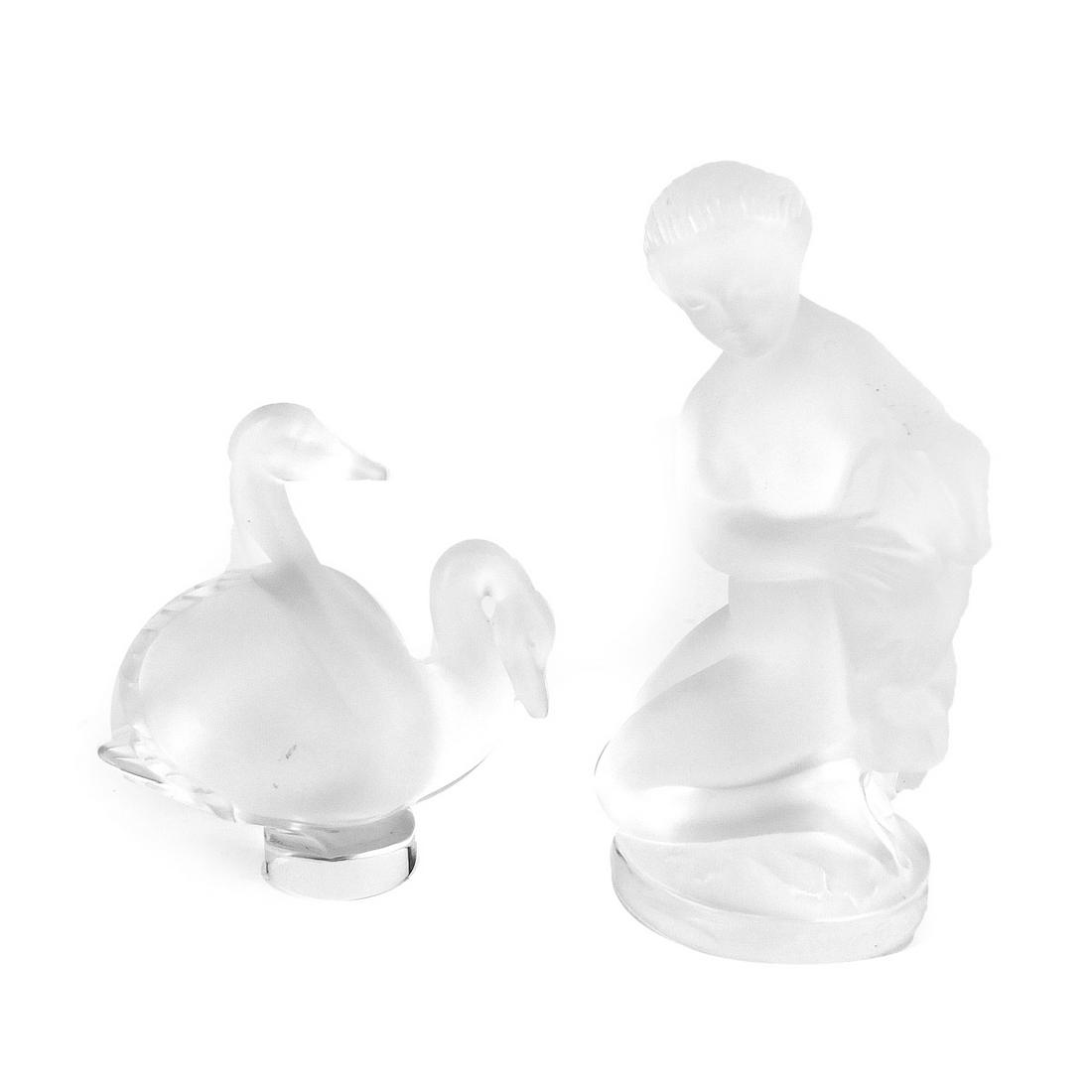 Lalique Tableware: Lalique Frosted Crystal Nude Lady Diana with Fawn Figurine along with a Lalique Double Swan Paperweight. Each is appropriately signed. Lady diana measures 4-5/8" x 2-1/2". Paperweight measures 3-1/4" 