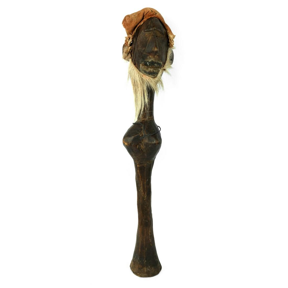African Hand Carved Sculpture: Large Antique African Banama Culture Hand Carved Male Figural Sculpture with Hat and Hair Embellishments. Measures 24-1/2" x 3-1/2" Condition: Some surface scuffs otherwise good condition. Estimate $5