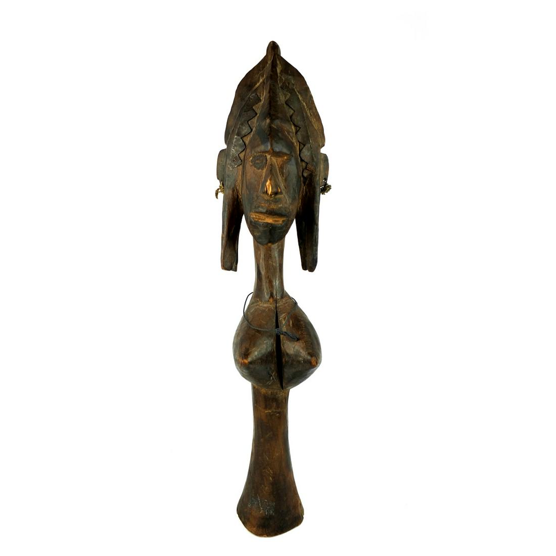 African Hand Carved Sculpture: Large Antique African Banama Culture Hand Carved Female Fertility Sculpture with Iron Mounts. Measures 27-3/4" x 6-1/4". Condition: Surface scuffs, split to the wood otherwise good condition. Estimate