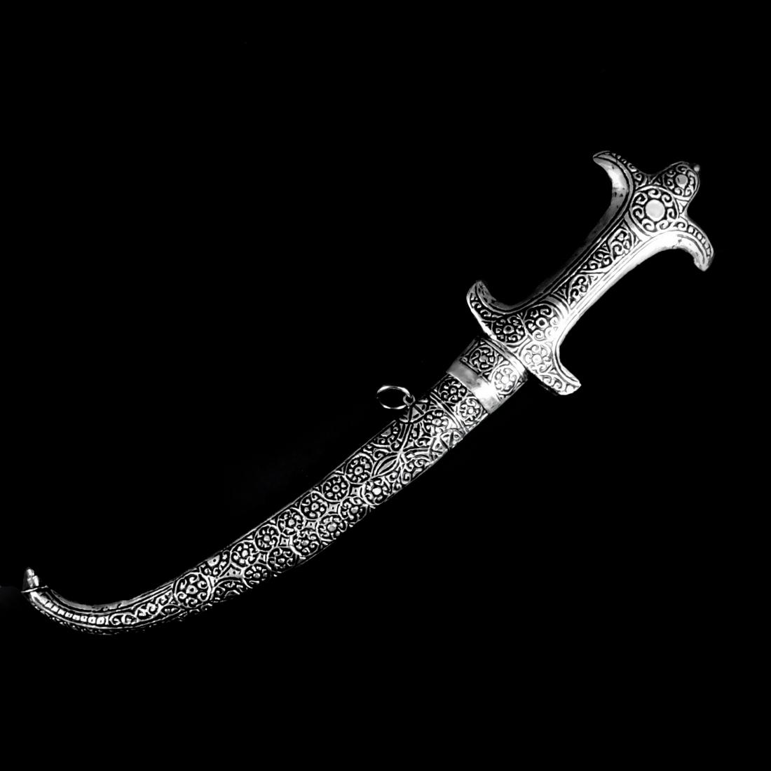 Middle Eastern Jambiya Dagger: 20th Century Middle Eastern Ornate Silver - Metal Jambiya Dagger / Knife. Continuous scrolled design on the surface, etched design on the blade. Overall measures 16". Condition: Good condition. Estima