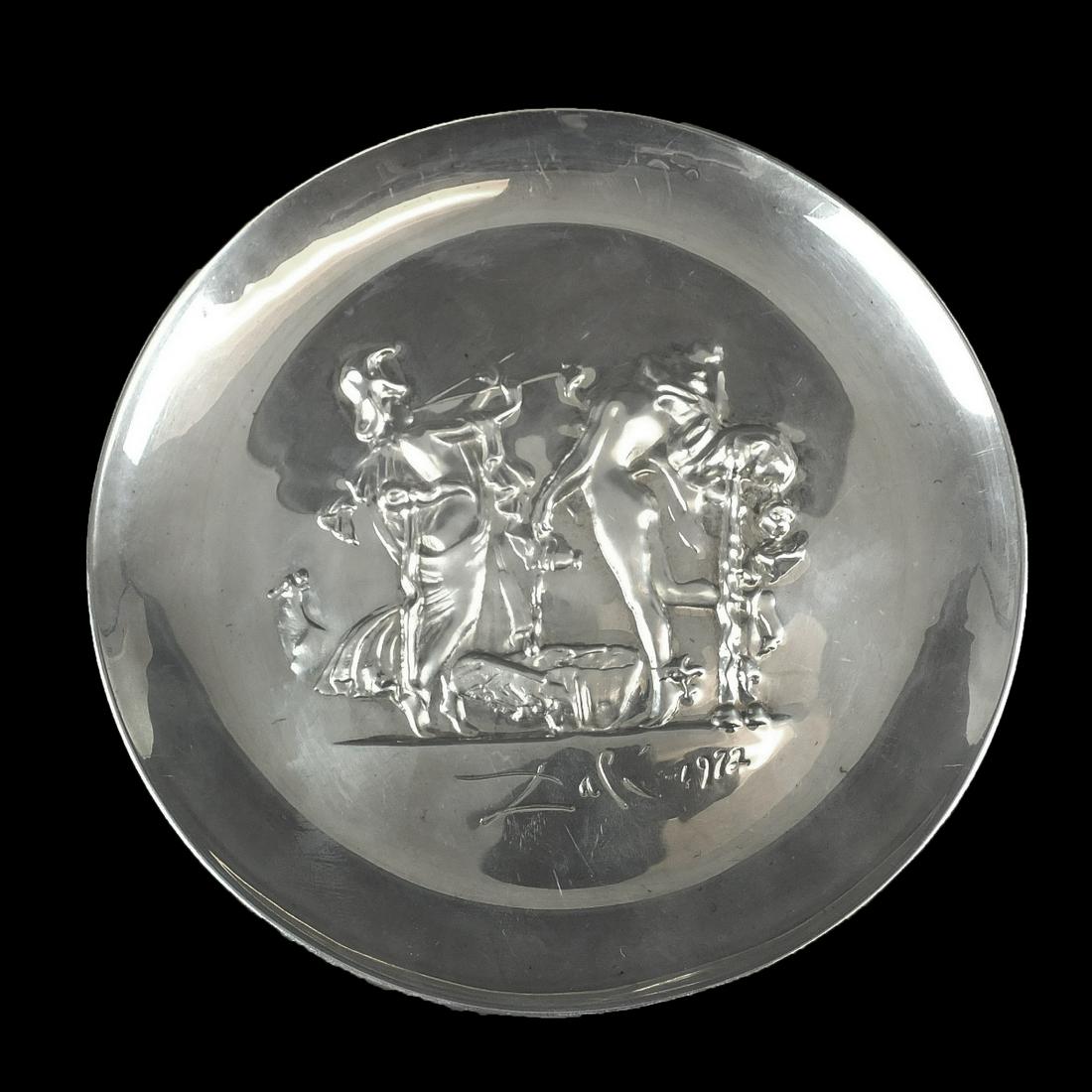 Salvador Dali (1904-1989) Sterling Plate: Salvador Dali, Spanish (1904-1989) "Dionysos of Athena" Sterling Silver Plate by Franklin Mint. Signed and dated. Marked and numbered 1456 on the bottom side. Measures 8". Weighs approx. 8.97 troy oun
