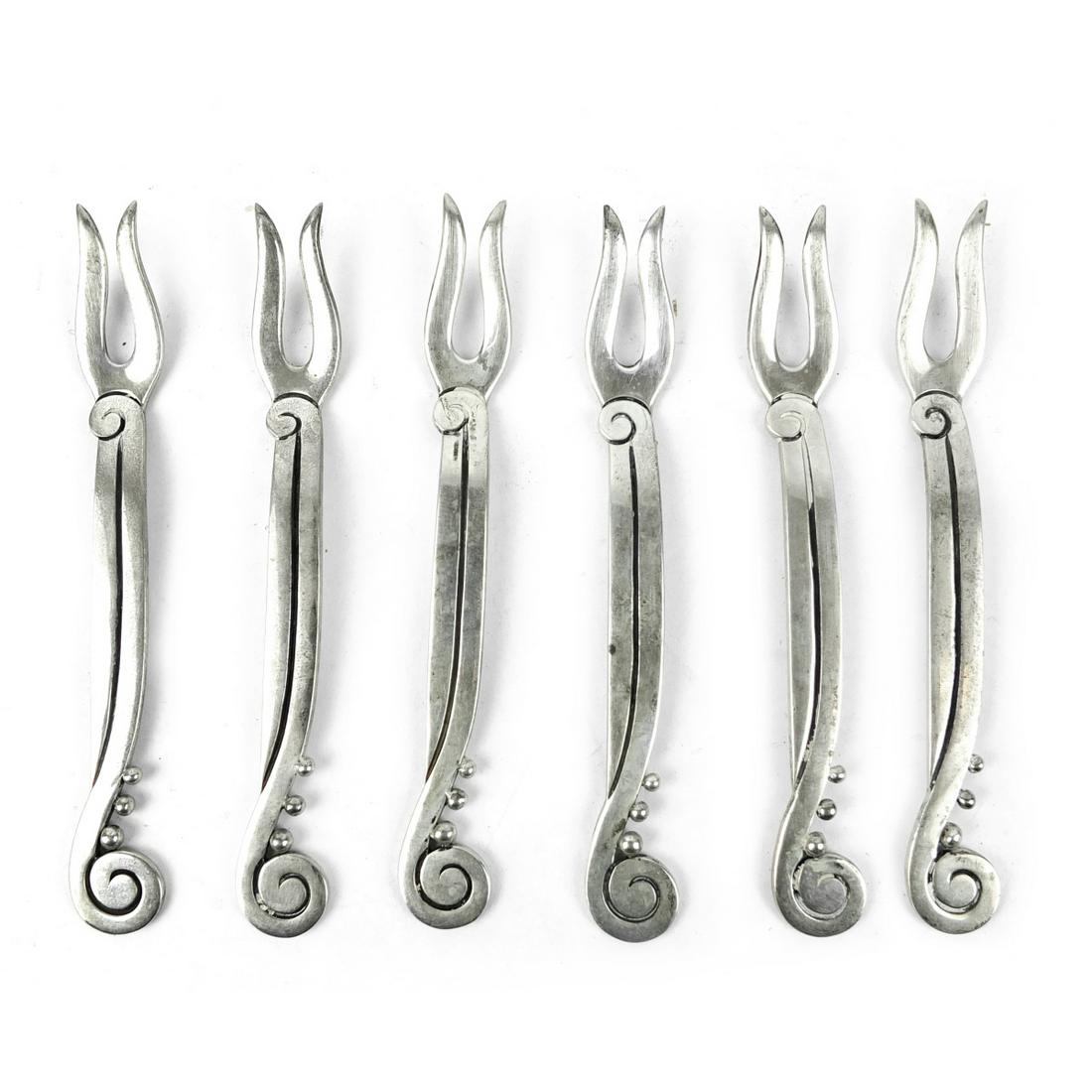 Taxco Cocktail / Seafood Forks: Set of Six Mexican Victoria Taxco Sterling Silver Modernist Cocktail / Seafood Forks. Stamped sterling and marked 03 with eagle. Designer Ana Nunez Brilanti. Measures 4-1/4". Approx. weight: 3.215 tro