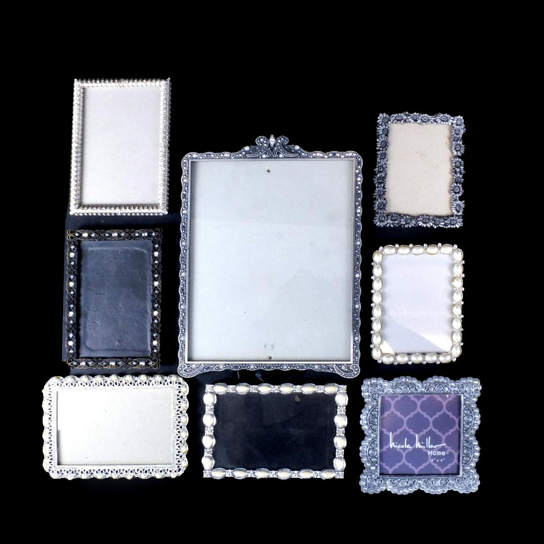 Picture Frames: Lot of Eight Assorted Picture Frames. Includes two frames signed Carr and Nicole Miller. Largest frame measures 11-1/2" x 8-1/2". Smallest measures 5-3/4" x 4-1/4". Condition: Good condition. Estimate