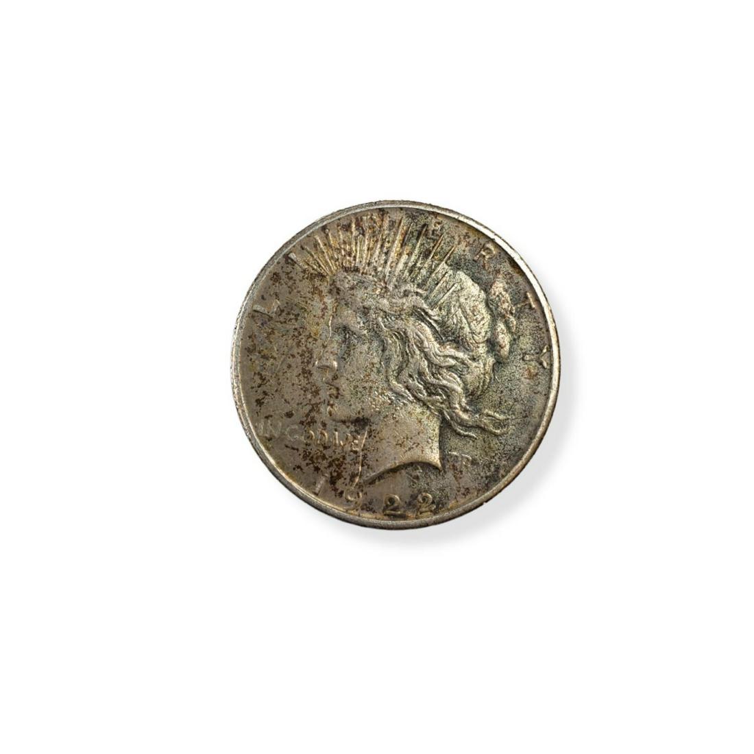 1922 U.S. Silver Peace Dollar: 1922 U.S. Silver Peace Dollar. Obverse: head facing left. Reverse: perched bird. Size: 38.1 mm. Weight: 26.73 grams. These coins has not been professionally graded. Condition: Needs cleaning otherwise