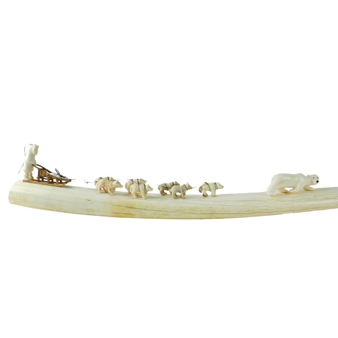 H.B. Slwooko, Siberian (20th C.) Tusk Carving: H.B. Slwooko, Siberian (20th Century) Large Yupik Eskimo Tusk Carving Depicting a Hunter in Dog Sled Chasing a Polar Bear. Signed on the bottom side. Measures 5-3/4" x 31-3/4" x 3". Please note; this 