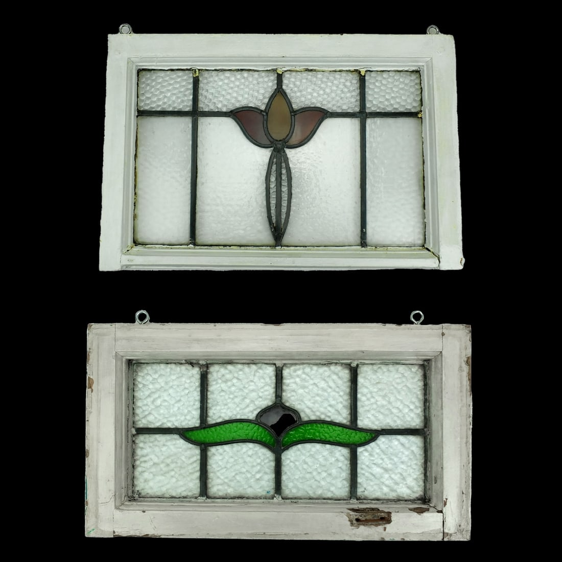 Two Vintage Leaded Glass Panels: Grouping of Two Vintage Leaded Glass Panels with Flower Motif. Largest measures 14-1/8" x 21-1/4". Smallest measures 12-1/8" x 21-1/2". Condition: Good condition. Estimate 100.00 - 300.00 Domestic shi
