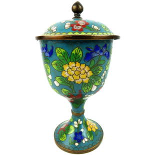 Chinese Cloisonné Chalice: 19th Century Chinese Enamel Covered Chalice. Surface decorated with continuous colored floral patterns over a blue ground surface. Measures 8-1/4" x 4". Condition: Wear to the enameling and ding locat