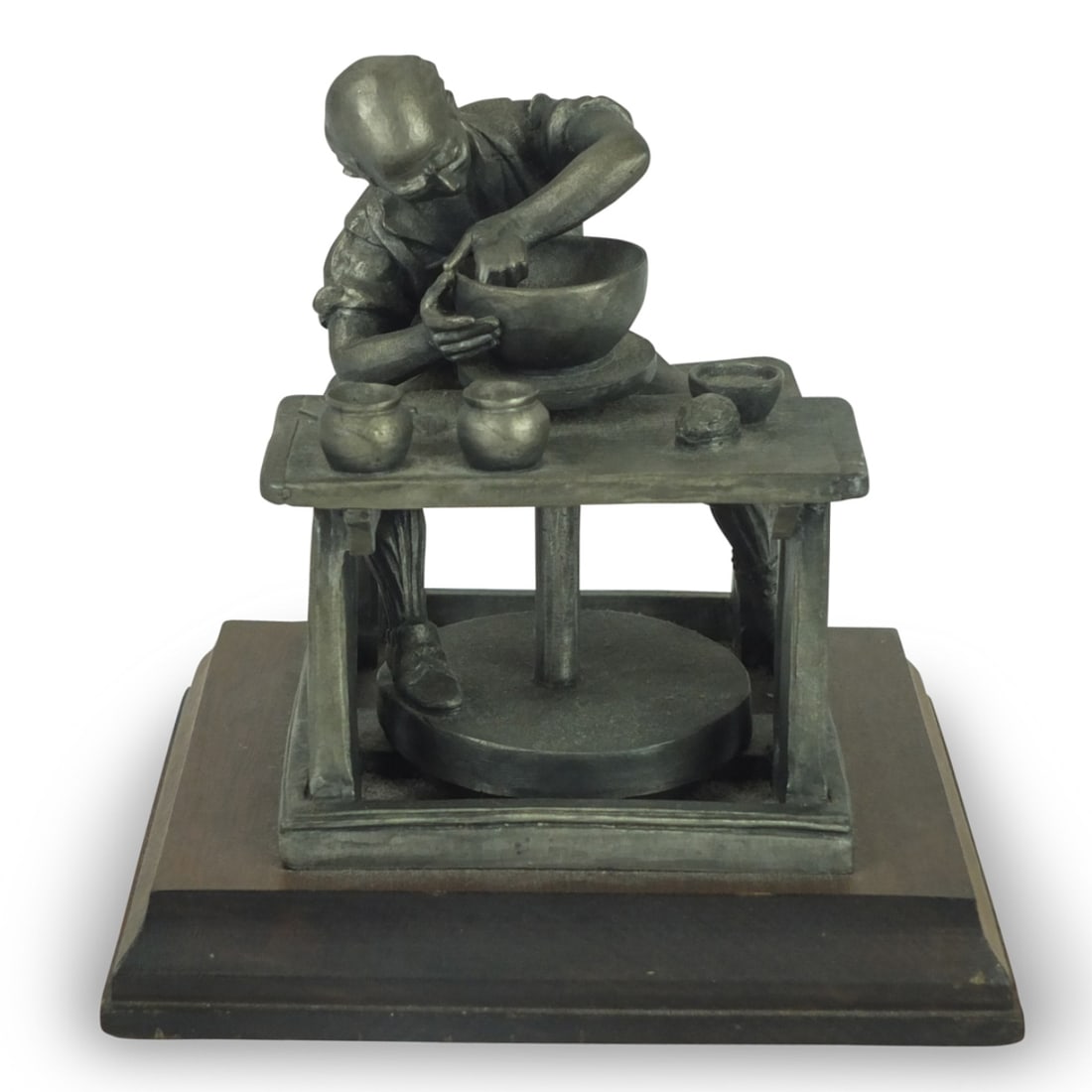 P. W. Baston (20th Century): P. W. Baston (20th Century) Pewter Sculpture presented on a wooden base. "Craftsman" signed and numbered 12 of 2500. Measures 6-1/4" x 6-1/2" x 6-1/2". Condition: Good Condition. Estimate 20 - 100 Dom