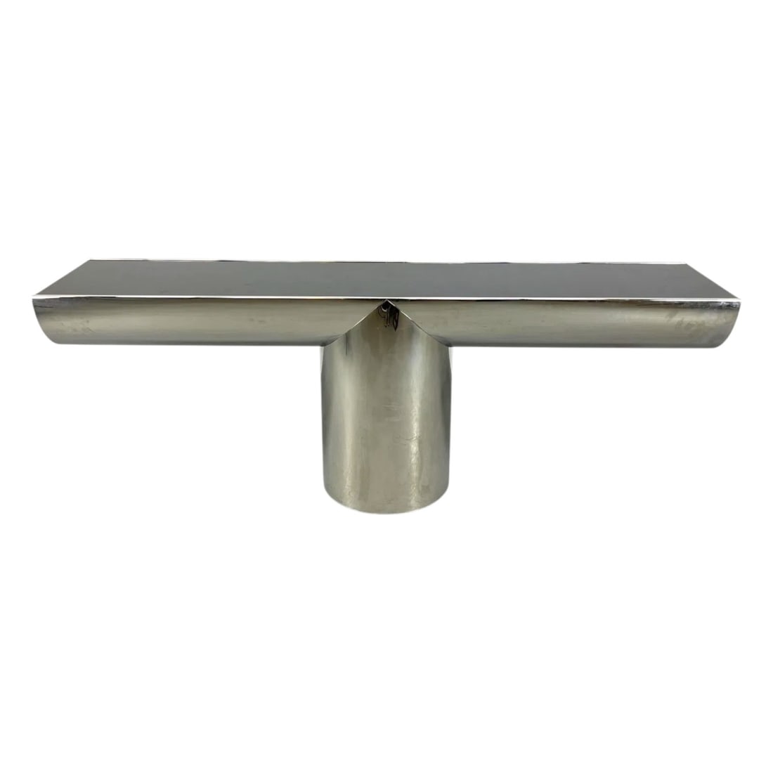 Brueton Console Table by J. Wade Beam: Brueton Stainless Steel "Tee" Console Table with Glass Top Designed By J. Wade Beam. Measures 30" x 84" x 18". Condition: Good condition. Estimate 3000 - 6000 Domestic shipping Third party