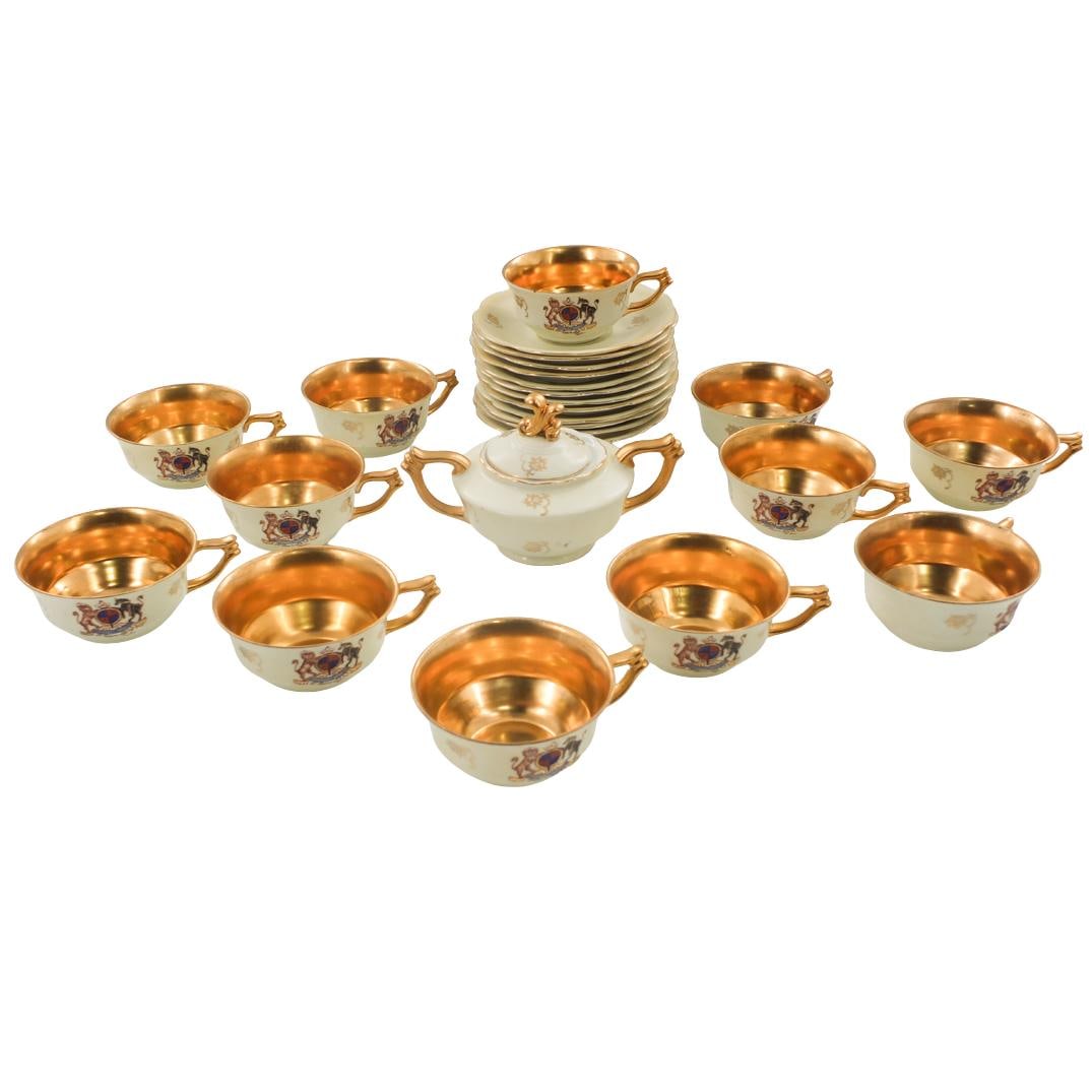 Antique Karlsbad Cups with Saucers: Set of Thirteen Antique Karlsbad Gilt Painted Porcelain Cups with Saucers. Includes (12) cups measuring 2" x 4", (12) saucers measuring 6" and covered sugar. Each piece is marked in the base. Conditio