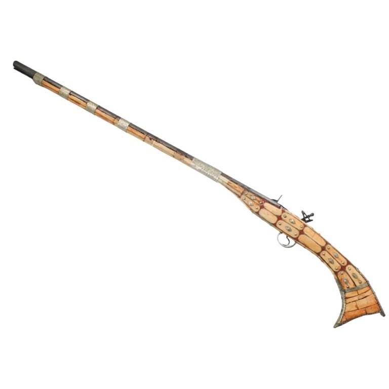 Antique Or Later Moroccan Inlaid Flintlock Rifle: Antique Or Later Moroccan Berber Bone Inlaid Flintlock Rifle. Measures 50-1/2" L. Condition: Oxidation to the barrel. Fittings are slightly loose. Trigger is loose. Seam split and wear near the flintl