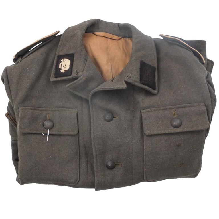 Men's German WWII SS Combat Tunic: Men's German WWII Waffen SS Combat Tunic. Skull insignia on the right collar.SS infantry EM shoulder broads. Size: medium. Please be advised: This item has not been authenticated by an independent exp