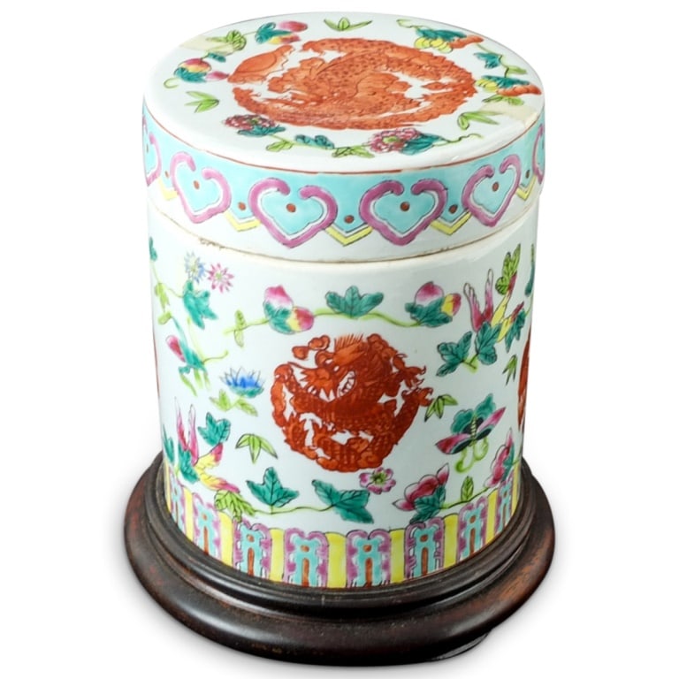 20th C. Chinese Porcelain Covered Jar: 20th Century Chinese Famille Rose Porcelain Covered Jar Presented on a Wooden Stand. Unsigned. Jar measures 6-7/8" x 5-1/2". Condition: Rubbing to the surface otherwise good condition. Base is for dis
