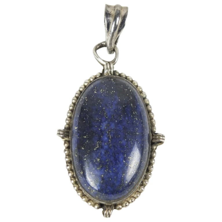 Vintage Sterling Silver and Lapis Lazuli Pendant: Vintage Sterling Silver and Lapis Lazuli Pendant. Unsigned. Measures 1-3/4" x 1". Approx. weight: 15 grams. Condition: Some bending to the hoop otherwise good condition. Estimate 50 - 150 Domestic shi