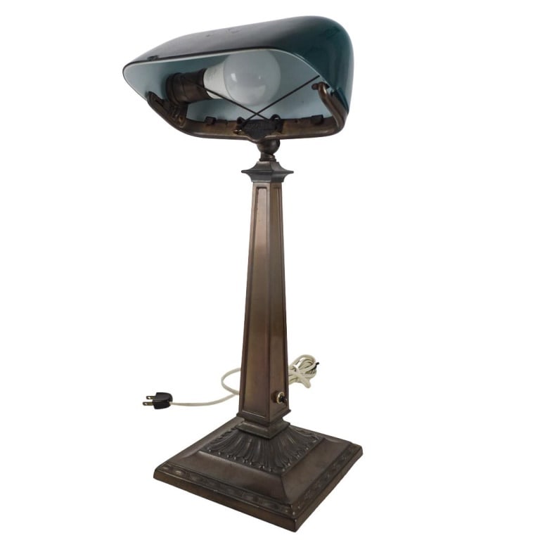 Antique H.G. Mc Faddin & Co. Emeralite Lamp: Antique H.G. Mc Faddin & Co. Emeralite Bankers Lamp with Glass Shade. Marked and numbered 8734. Measures 18-1/2" x 6-3/4" x 6-3/4". Condition: Small chip to the rim of the glass shade. Estimate 200 - 