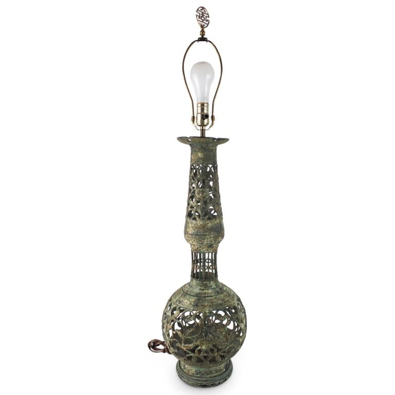 Large Chinese Archaic Style Bronze Lamp: Large Chinese Archaic Style Reticulated Bronze Candle Holder Presented as a Lamp. Overall measures 38-1/2" x 9". Candle holder height: 25". Condition: No harp otherwise good condition. Estimate 50.00