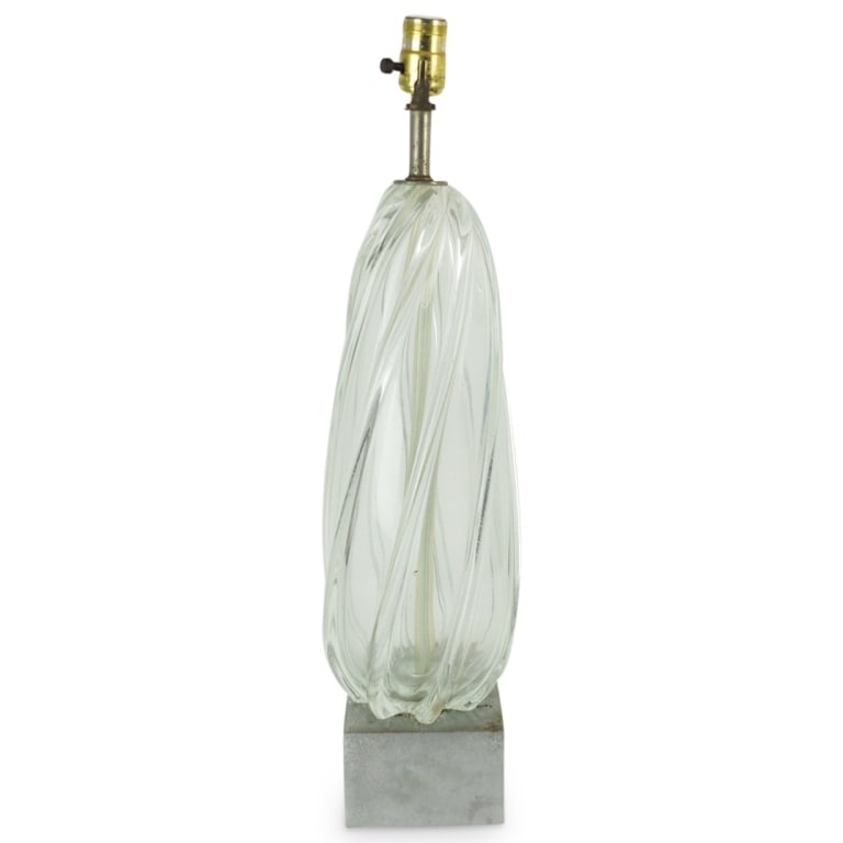 Vintage Murano Segusso Glass Lamp: Vintage Murano segusso swirl glass lamp presented on chrome. Measures 24-1/4" x 5-3/4". Condition: Pitting and corrosion to the chrome, no harp otherwise good condition. Estimate 100 - 150 Domestic sh