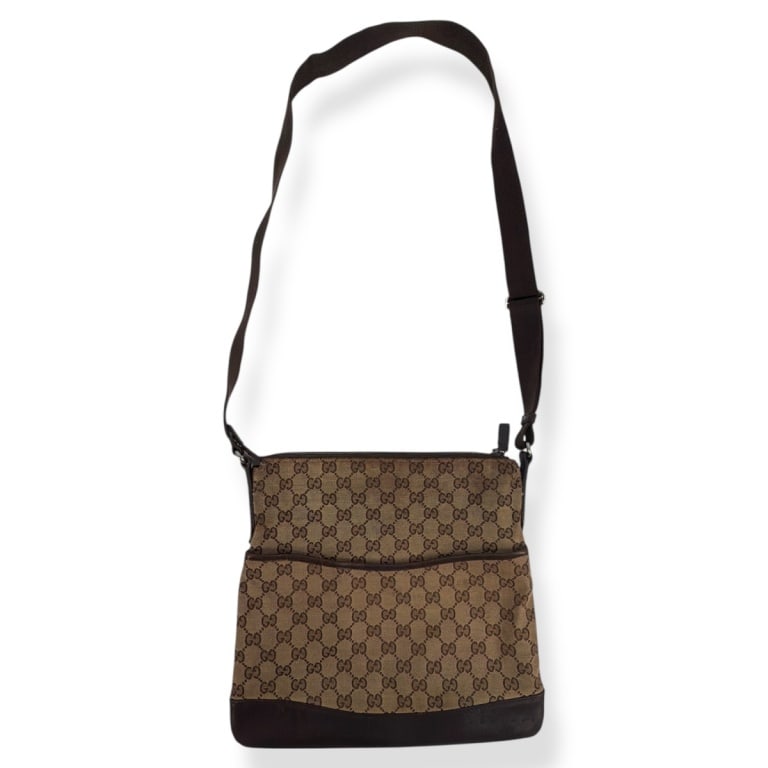 Gucci GG Canvas Crossbody Bag: Gucci GG Canvas Crossbody Bag. Dark brown leather trim, adjustable canvas strap. Measures 11" x 12" x 1". Condition: Some soiling and wear at top consistent with use, overall good condition. Estimate