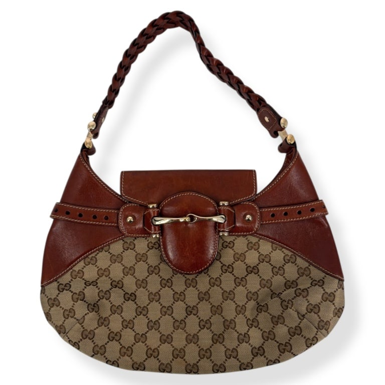 Gucci GG Canvas Horsebit Shoulder Bag: Gucci GG Canvas Horsebit Shoulder Bag. Brown leather trim and braided strap. Dust bag included. Measures 10" H x 14" W x 1", 8" drop. Condition: Good pre-owned condition with light wear consistent wit