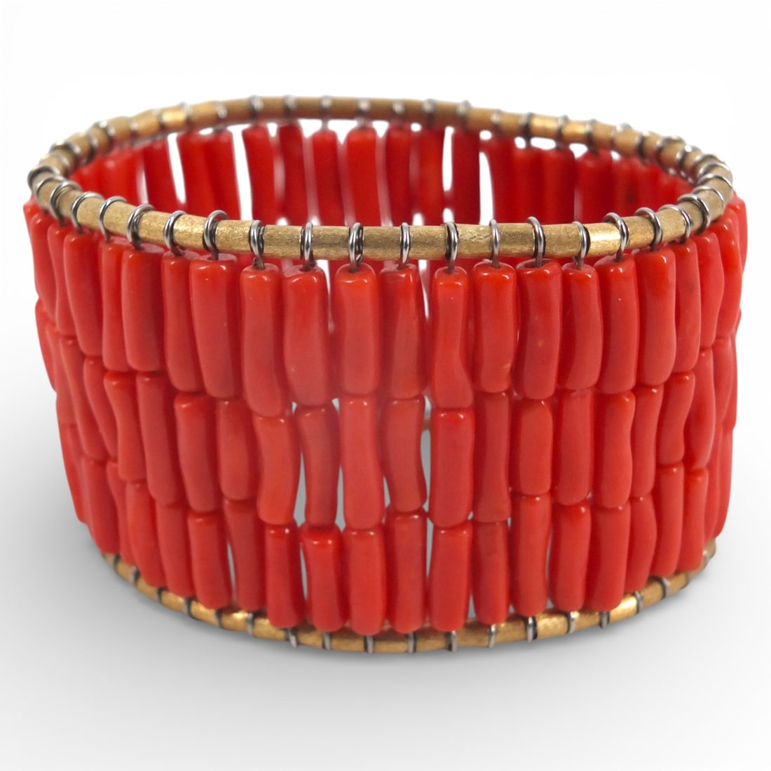 Loffredo Coral & 18K Gold Stretch Cuff Bracelet: Loffredo Italian Coral Stretch Cuff with 18K yellow gold edging. Cuff measures approximately 3" in height. Oblong tubular gem quality coral forms the body of this cuff. Strong, stainless steel wires h