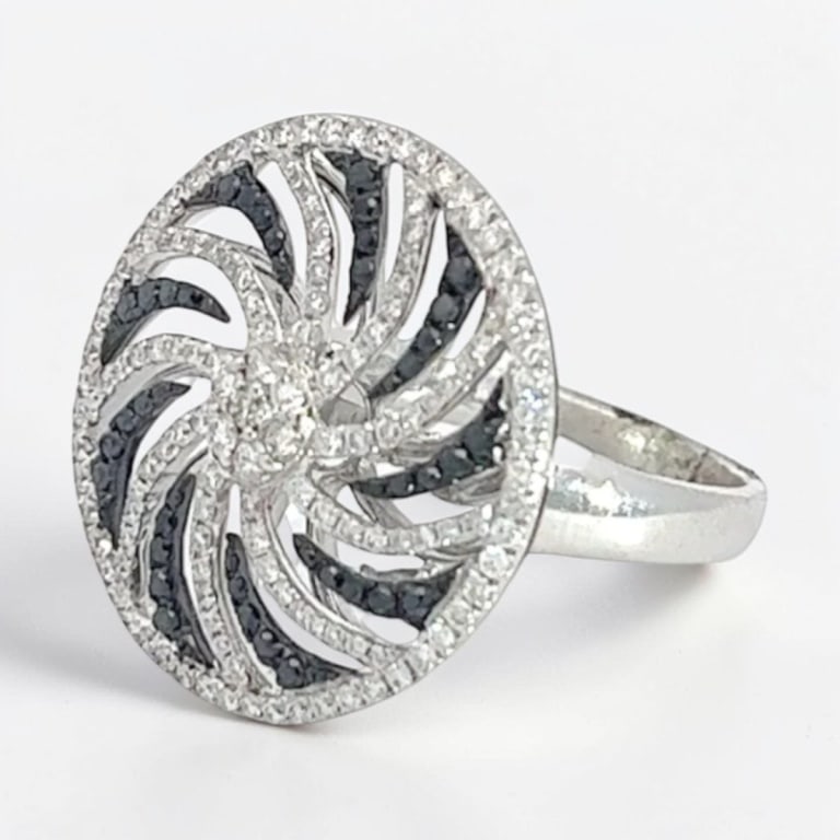 Vintage Diamond & 18K Ring: Vintage 18 Karat White Gold Diamond Whirlwind Ring. Diamonds: approx. .60 carat round diamond, approx. .15 carat round black diamond. Size: 7. Approx. weight: 6.9 grams. Condition: Good condition.