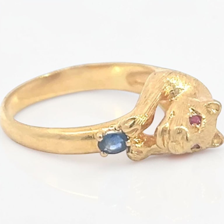 Vintage Cartier Style 18K Ring: Vintage Cartier Style 18 Karat Yellow Gold Ring with Ruby and Blue Sapphire Embellishments. Size: 6. Approx. weight: 5.4 grams Condition: Good condition. Estimate 1000 - 1500 Domestic shipping Third