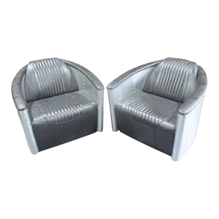 Pair of Aviator Lounge Chairs: Pair of Aviator Leather and Aluminum Lounge Chairs. Measures 28-1/2" x 32-1/4", 16-1/2" seat height. Condition: Leather has some wear and touch ups near the hand rests. Dings to the aluminum.