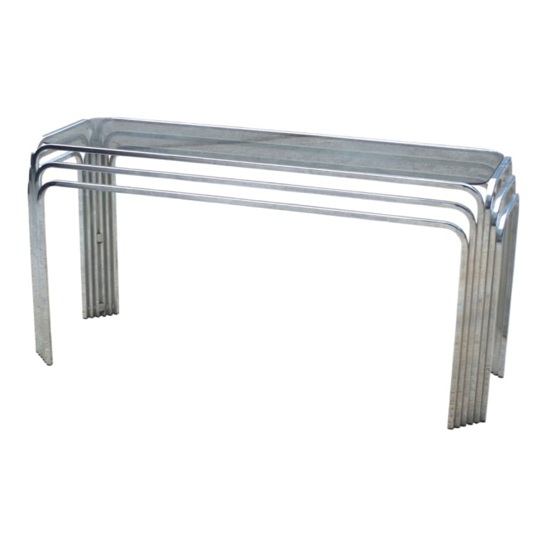 Circa 1970s Art Deco Style Chrome Console Table: Circa 1970s Art Deco Style Chrome and Smoke Glass Console Table. Measures 27" x 53" x 18-1/2". Condition: Chrome has some pitting to the surface. Estimate 200 - 400 Domestic shipping Third party