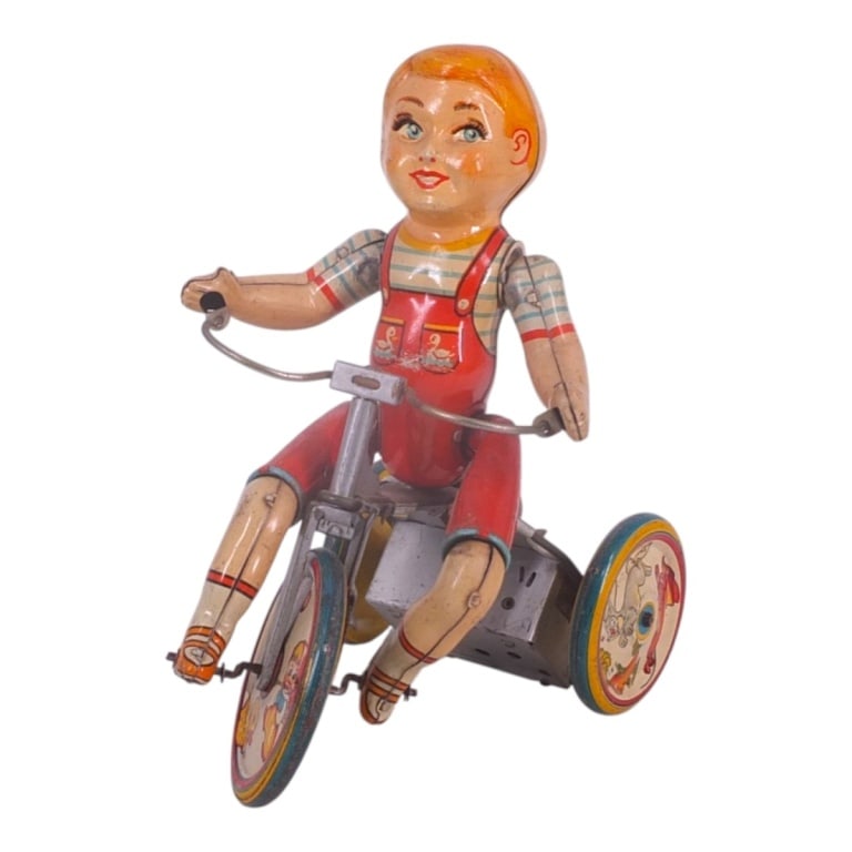 Unique Art Mfg. Co. Kiddy Cyclist Tin Toy: Circa 1930's Unique Art Mfg. Co. Kiddy Cyclist Wind Up Tin Toy. Marked. Measures 9" x 4-1/2" x 7-1/2". Please note that the working condition of the mechanical components of this lot is not guaranteed