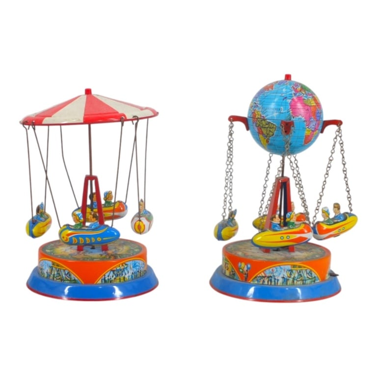 Pair of German Tin Merry Go Round Toys: Pair of Circa 1950s German Tin Merry Go Round Toys. Marked. Tallest measures 8-1/4" x 5". Smallest measures 7-1/2" x 4-7/8". Please note that the working condition of the mechanical components of