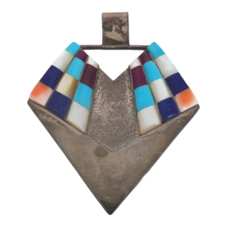 Vintage Zuni Sterling Inlay Pendant: Vintage Zuni Sterling Inlay Pendant. Inlaid with turquoise, lapis, sugilite etc. Stamped Sterling. Measures 2-3/4" x 2-1/2". Weighs approx. 22 grams. Condition: Good condition. Estimate 50 - 75 Domest