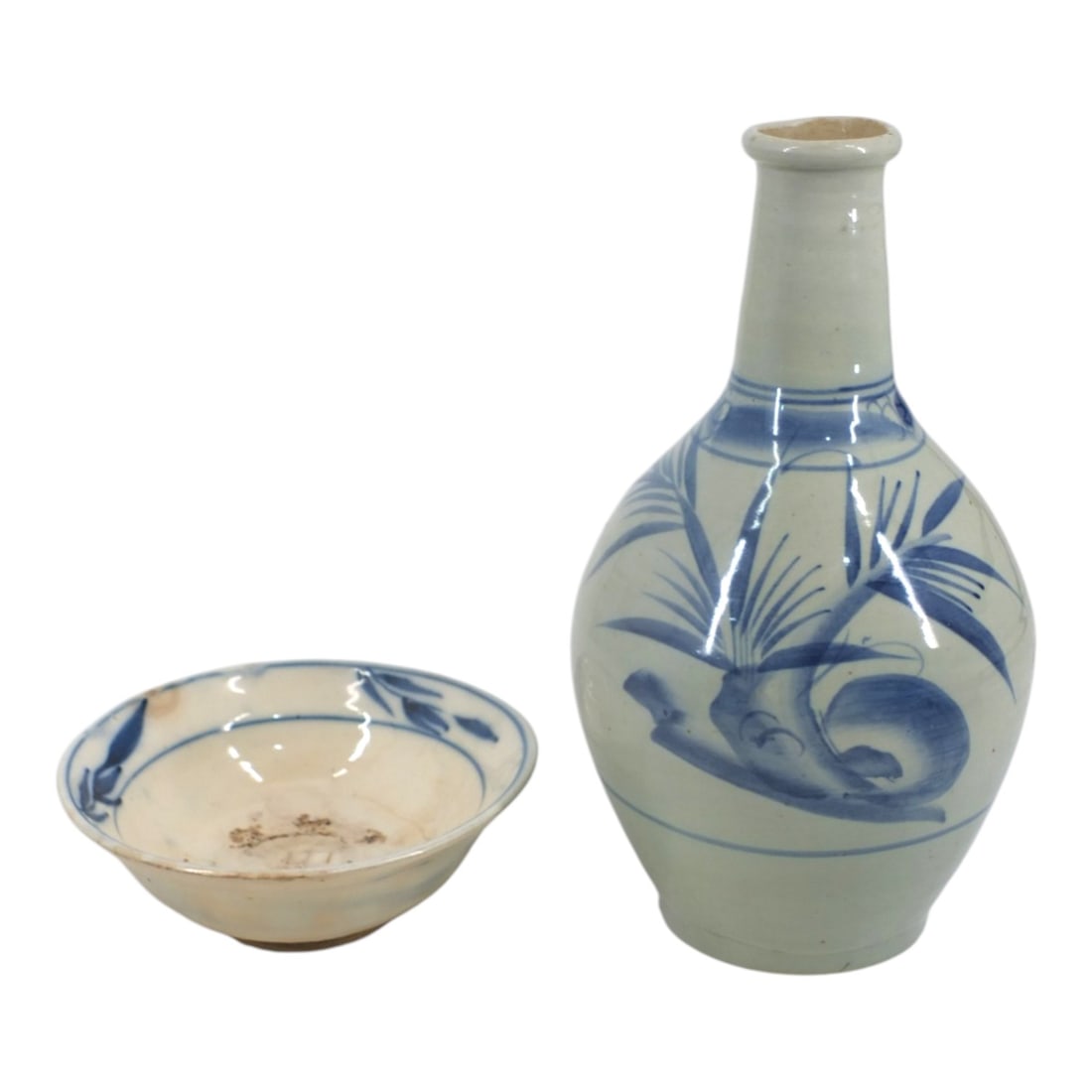 Two Japanese Porcelain Table Top Objects: Two Japanese Porcelain Table Top Objects. Includes an antique blue & white porcelain Tokkuri / sake bottle or vase 10-1/2" H, Unsigned. Also an antique blue & white noodle bowl. Signed with raised T