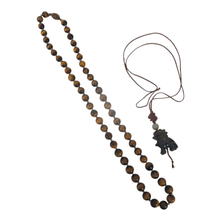 Vintage Tiger Eye Beaded Necklace and Pendant: Vintage Tiger Eye Beaded Necklace and Carved Foo Lion Pendant Necklace. Unsigned. Beaded measures 12" with silver locking clasp. Pendant measures 1-1/2" on a 13" knotted silk strand. Unsigned.