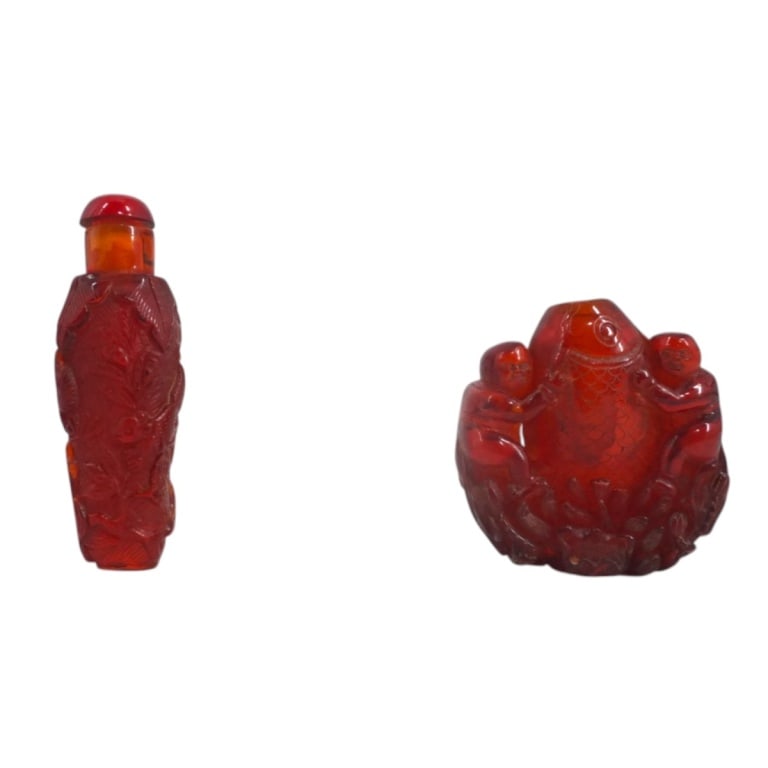 2 Chinese Carved Amber Snuff Bottles: 2 Chinese Carved Amber Snuff Bottles. Unsigned. Measures 3" , 2-1/8". Condition: 1 top missing or in good condition. Estimate 200 - 400 Domestic shipping Third Party