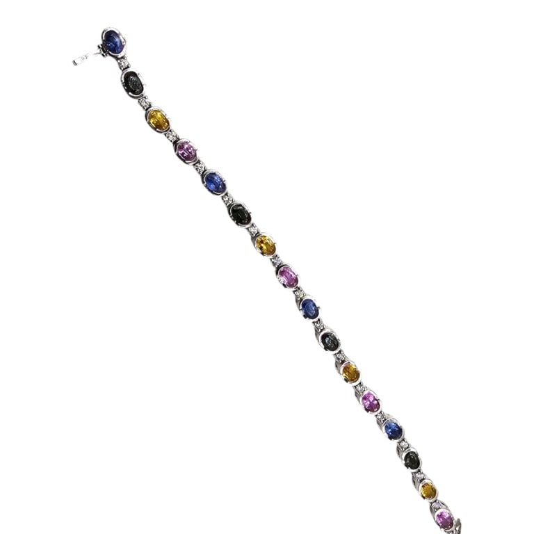Vintage 14K Diamond & Sapphire Bracelet: Vintage 14 Karat White Gold Diamond and Rainbow Sapphire Bracelet. 9.88 TCW sapphire .79 TCW diamond G - VS2. Stamped. Measures 7" L. Approx. weight: 17.3 grams. Please note: Due to increased