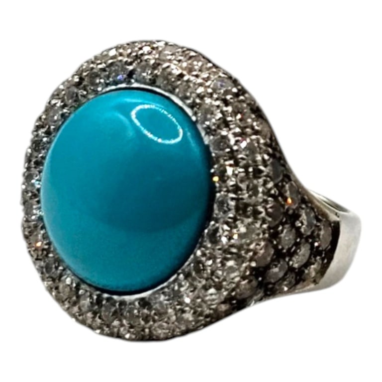 18K Diamond and Turquoise Ring: 18 Karat White Gold Chocolate and White Diamond and Turquoise Ring. Size: 6.5. Approx. weight: 13 grams. Please note: Due to increased fraudulent activity, customers without an established bidding
