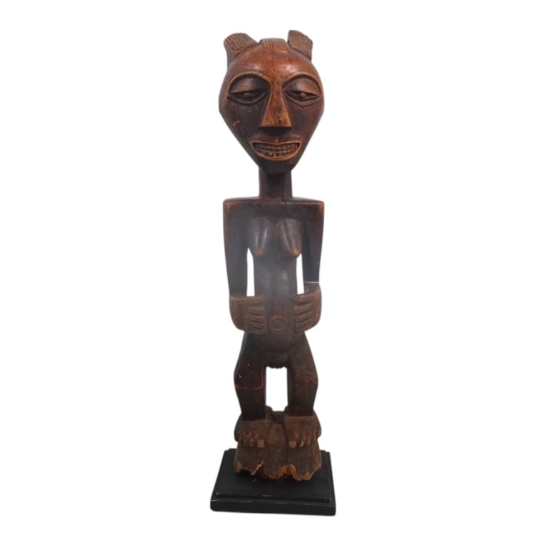African DRC Carved Wood Songye Figure: African Democratic Republic of Congo Carved Wood Songye Figure, known as an Nkisi. Unsigned. Measures 34-1/2" H. Condition: Age splits, wear consistent with age. Estimate 160 - 320 Domestic shipping
