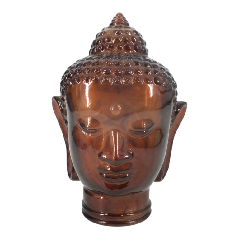 Bronze/Brown Glass Buddha Head Sculpture: Bronze/Brown Glass Buddha Head Sculpture. Unsigned. Measures 12". Condition: Good condition with no chips or cracks. Estimate 80 - 120 Domestic shipping Third Party