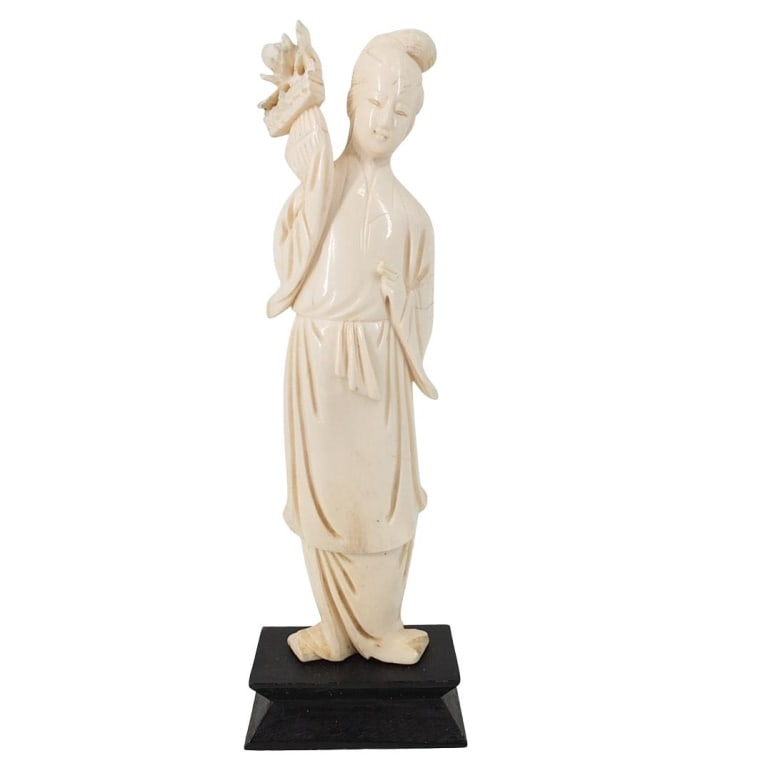 Antique Chinese Carved Figurine: Antique Chinese Carved Figurine Holding a Flower Represented on a Wooden Base. Overall measures 6-3/4" x 2-3/4" x 1-1/4". Figure measures 6-1/2" high. Please note; this lot contains material which may