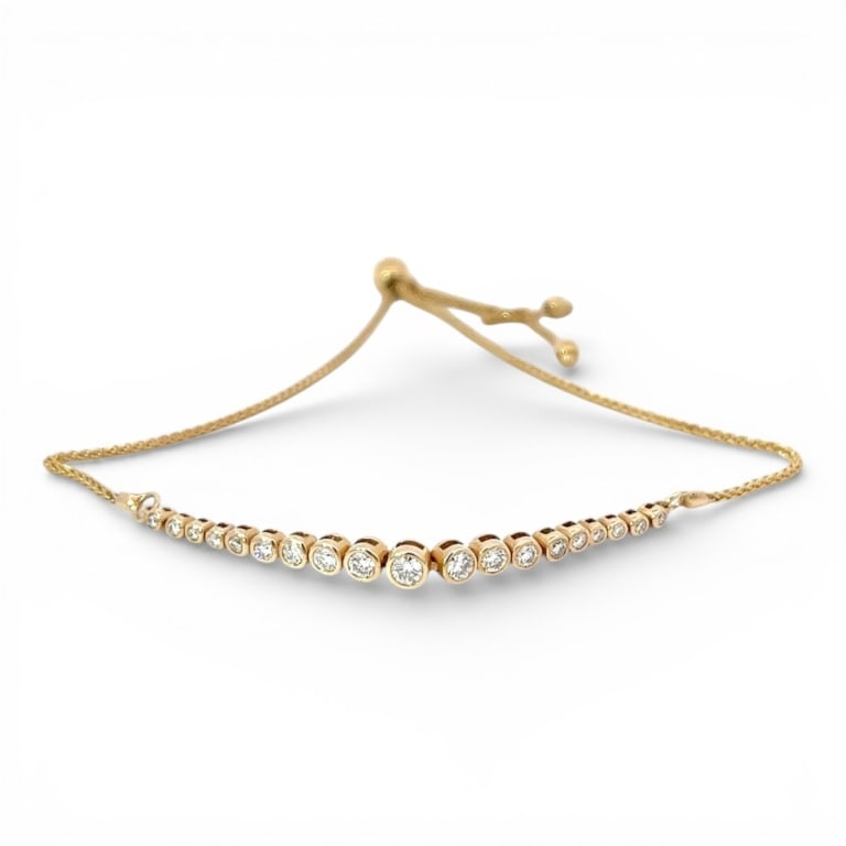 Vintage 14K Gold & Diamond Bracelet: Vintage 14 karat yellow gold and .50 carat round Bezel Set diamond bolo bracelet Stamped. Color: G Clarity:VS2. Measures: Approx. weight: 3.7 grams. Condition: Good condition. Estimate 800 - 1200