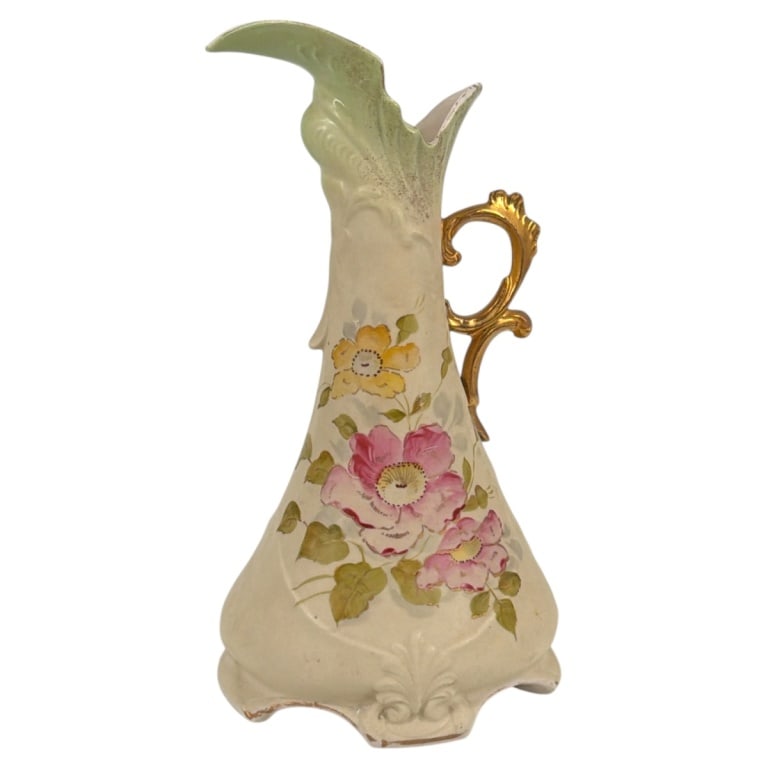 Antique Turn-Teplitz Austria Porcelain Ewer: Antique Teplitz Austria Porcelain Ewer. Decorated with a hand painted floral motif on cream ground with gilt highlights. Measures 11-3/4 H x 6-1/4" x 5-1/2". Condition: Small flake on foot, light