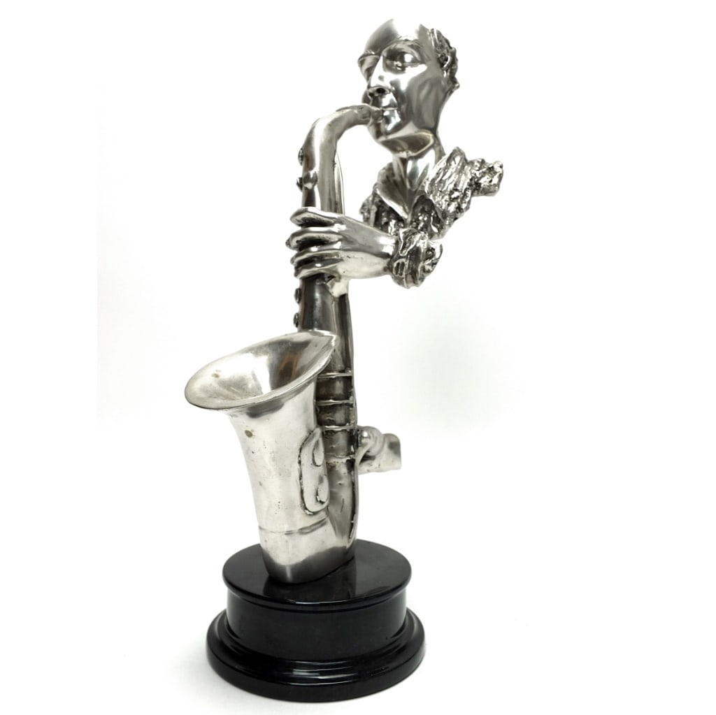 Tall Silvered Bronze Sculpture of a Saxophonist: Tall Modern Silvered Bronze Sculpture of a Saxophonist Presented on a Marble Base. Unmarked. Measures 14-3/8" x 5" x 8-1/2". Condition: Good condition. Estimate 50.00 - 150 Domestic shipping Third