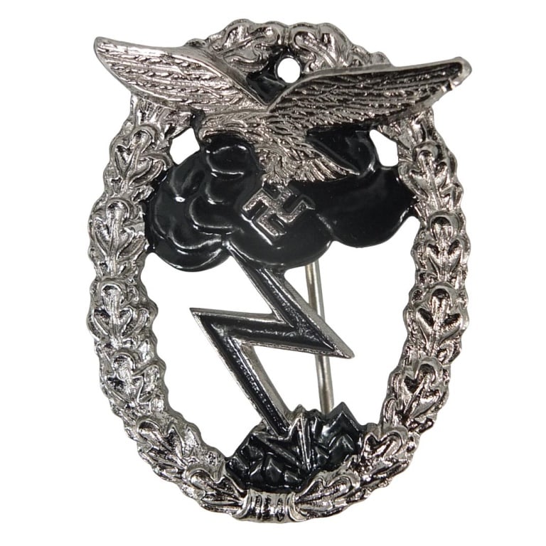 German WWII Luftwaffe Badge: German WWII Luftwaffe Metal and Enameled Ground Assault Badge. Designed by Rudolf Karneth R.K. Measures 2-1/8" x 1-5/8". Please be advised: This item has not been authenticated by an independent