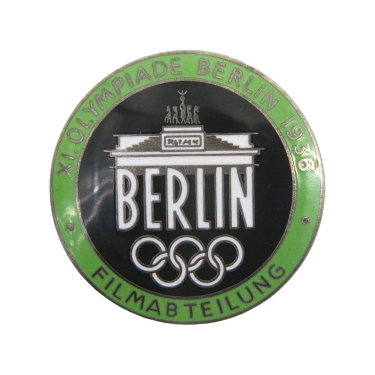 German WWII 1936 Berlin Summer Olympics Badge: German WWII 1936 Berlin Summer Olympics Filmmaker Badge. Marked Rob Neff Berlin W 57 on the reverse side. Measures 1-7/8" diam. Please be advised: This item has not been authenticated by an