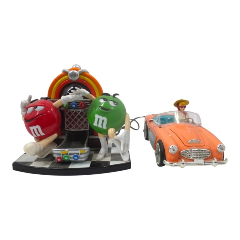 Vintage Barbie Car Clock & M&M's Jukebox: Vintage 1996 Barbie Car Clock Radio, 5" H x 12" x 6" & M&M's Rock 'n Roll Cafe Jukebox Candy Dispenser, 11" H x 9-1/2" x 5-1/2". Condition: Both in need of cleaning or in working order. Rear bumper