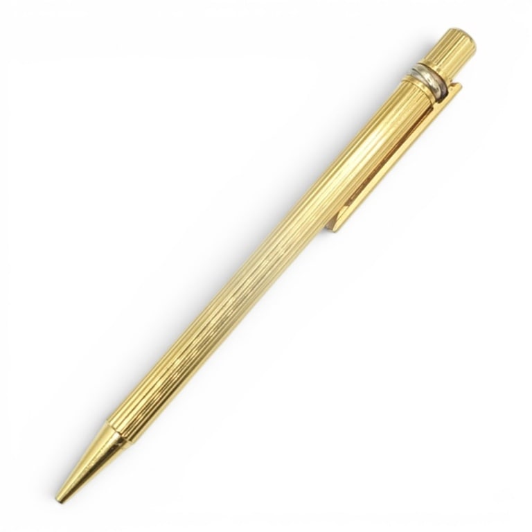 Cartier "Must de Cartier" Pen: Cartier "Must de Cartier" Trinity Gold Plated Ballpoint Pen. Measures 5-3/4". Condition: Good condition. Estimate 300 - 500 Domestic shipping Third party