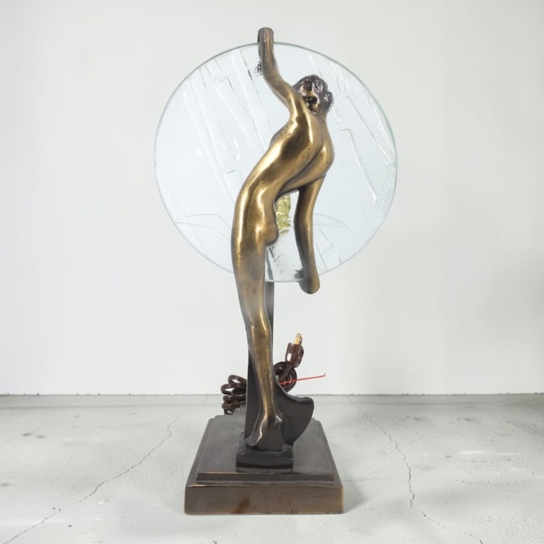 Art Deco Style Bronze Figural Nude Lamp: Art Deco Style Patinated Bronze Figural Nude Lamp. With a bamboo relief clear glass disc. Unsigned. Measures 14-1/2" x 5-1/2" x 4-1/4". Condition: No shade. Good condition. Estimate 100 - 300