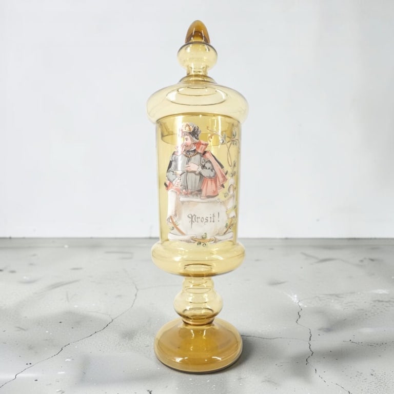 Bohemian Enameled Glass Covered Jar "Prosit!": Bohemian Enameled Amber Glass Covered Jar. Hand painted "Prosit!". Unsigned. Measures 15-1/2" H. Condition: A few minor flea bites on rim or in good condition. Estimate 160 - 320 Domestic shipping