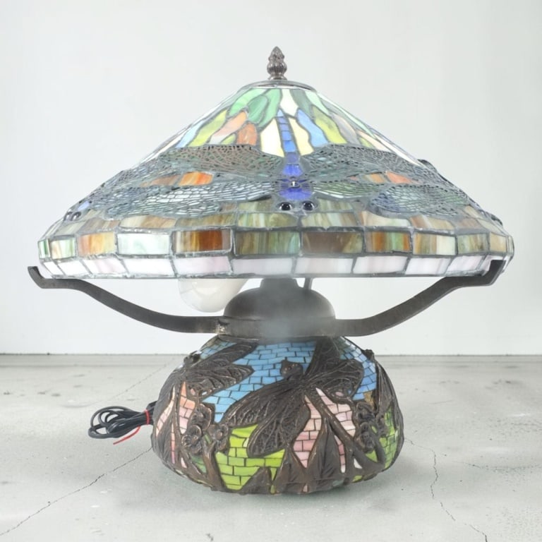 Tiffany Style Leaded Glass Dragonfly Lamp: Tiffany Style Leaded Glass Dragonfly Lamp. 3 lights. Unsigned. Measures 16" H overall, shade 9" x 16", base 11-1/2 to top of sockets. Condition: Good condition. Estimate 200 - 300 Domestic shipping